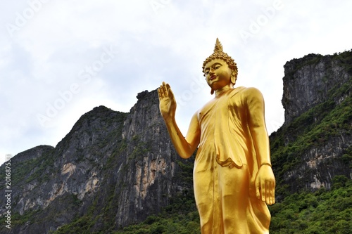 The attitude of persuading the relatives not to quarrel symbol of Golden Buddha statue  with mountain background at Soun Wi Wek Buddhist Priests House,Sam Roi Yot, Prachuap Khiri Khan,Thailand
 photo