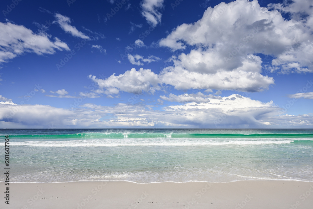 Enjoy this amazing sea view with pure sandy beach and crystal clear blue water a few waves coming to the shore at a lonely empty place on Tasmania, Australia Enjoy this amazing sea view with pure sandy beach and crystal clear blue water a few waves coming to the shore at a lonely empty place on Tasmania, Australia