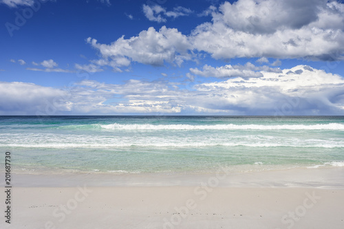 Enjoy this amazing sea view with pure sandy beach and crystal clear blue water a few waves coming to the shore at a lonely empty place on Tasmania, Australia
