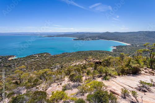 Wonderful view to stunning sandy beach blue turqouise water on warm sunny day with blue sky relaxing after hiking on top Mount Amos, Wineglass, Freycinet National Park, Coles Bay, Tasmania, Australia