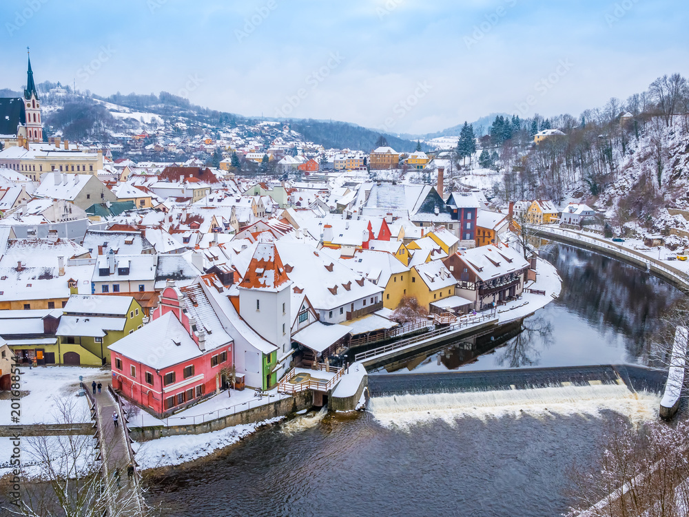 Panoramic view of Cesky Krumlov in winter season, Czech Republic. View of the snow-covered roofs. Travel and Holiday in Europe. Christmas and New Year time. Sunny winter day in european town.