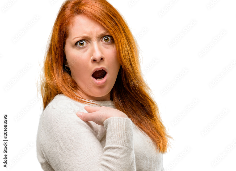 Beautiful young redhead woman scared and surprised cheering expressing wow gesture. Unbelieving isolated over white background Beautiful young redhead woman scared and surprised cheering expressing wow gesture. Unbelieving isolated over white background