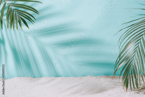 Fototapeta Naklejka Na Ścianę i Meble -  Summer concept. Palm tree shadow on a blue  background.