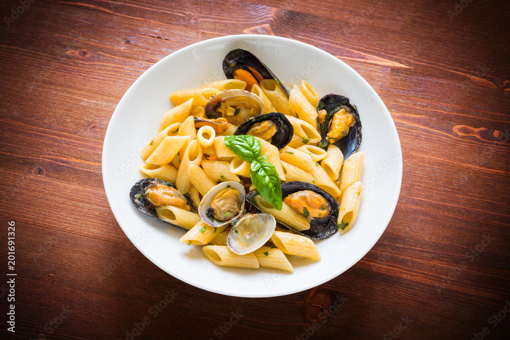 Penne allo scoglio, dish of italian pasta with clams and mussels, Mediterranean Food Penne allo scoglio, dish of italian pasta with clams and mussels, Mediterranean Food