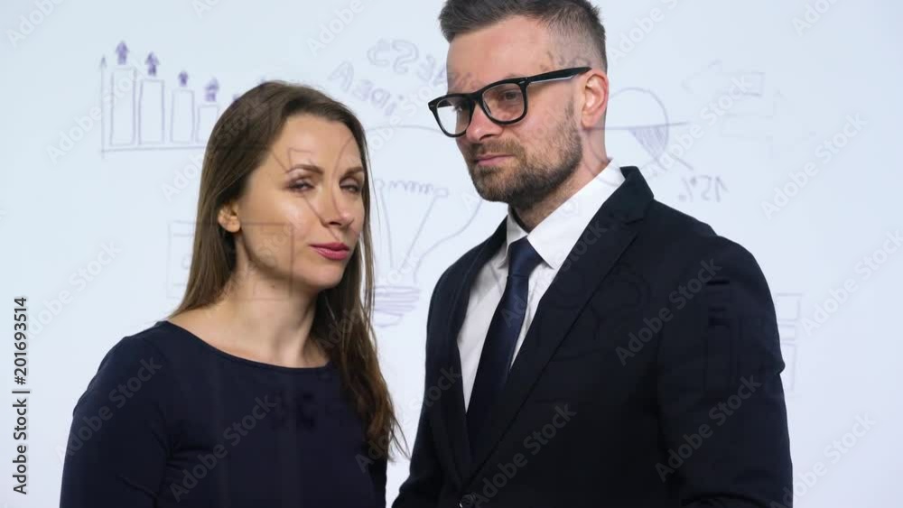 Man and woman discuss the business strategy for success and having fun in a modern glass office Man and woman discuss the business strategy for success and having fun in a modern glass office