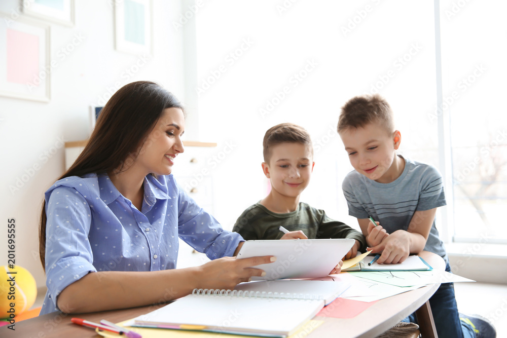 Cute little children with teacher in classroom at school Cute little children with teacher in classroom at school