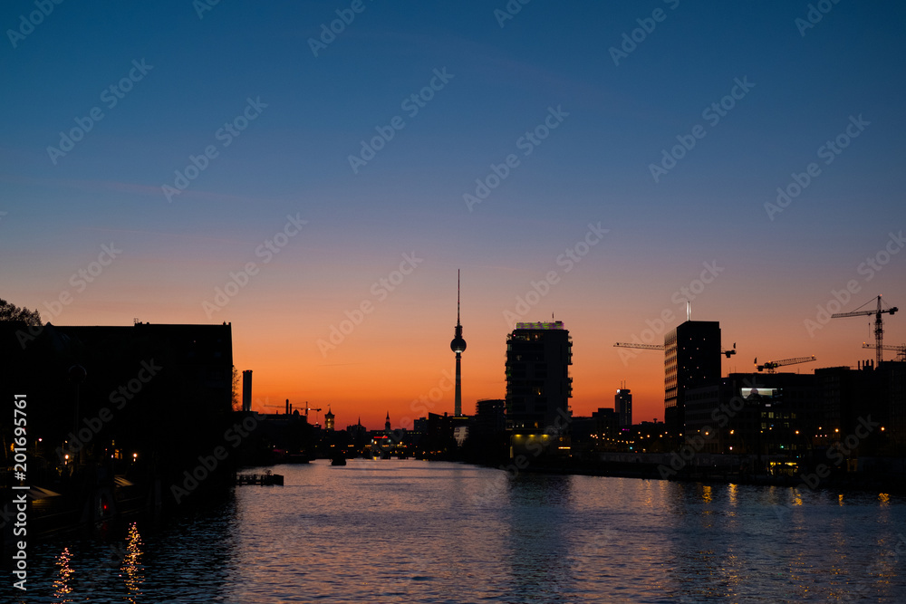 Berlin skyline sunset sky and tv tower at river spree