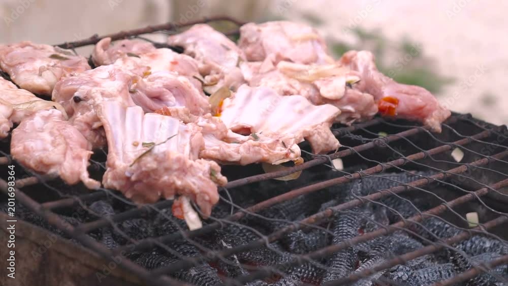 Male hand putting minced meat kebabs on barbecue. Male hand putting minced meat kebabs on barbecue.