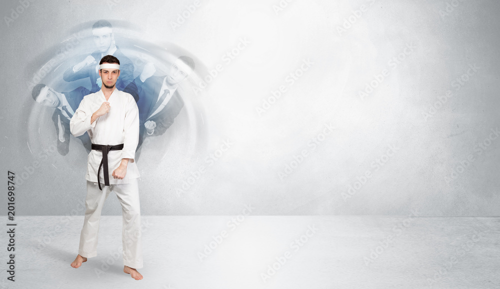 Young businessman in suit fighting with empty wall background
Young businessman in suit fighting with empty wall background
