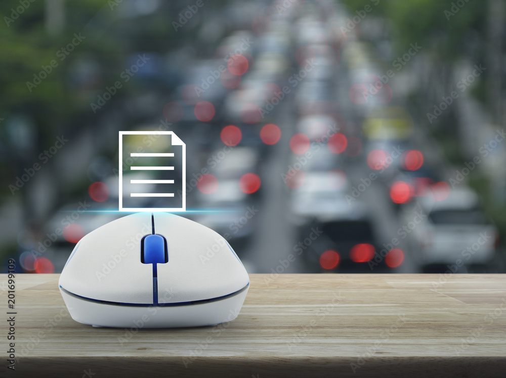 Document icon with wireless computer mouse on wooden table over blur of rush hour with cars and road, Business communication concept Document icon with wireless computer mouse on wooden table over blur of rush hour with cars and road, Business communication concept
