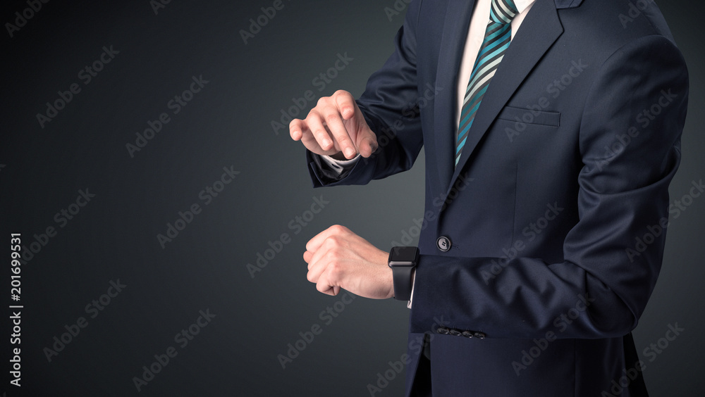 Man wearing suit with smartwatch on his wrist.