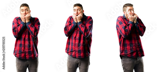 Young man terrified and nervous expressing anxiety and panic gesture, overwhelmed isolated over white background, collage composition