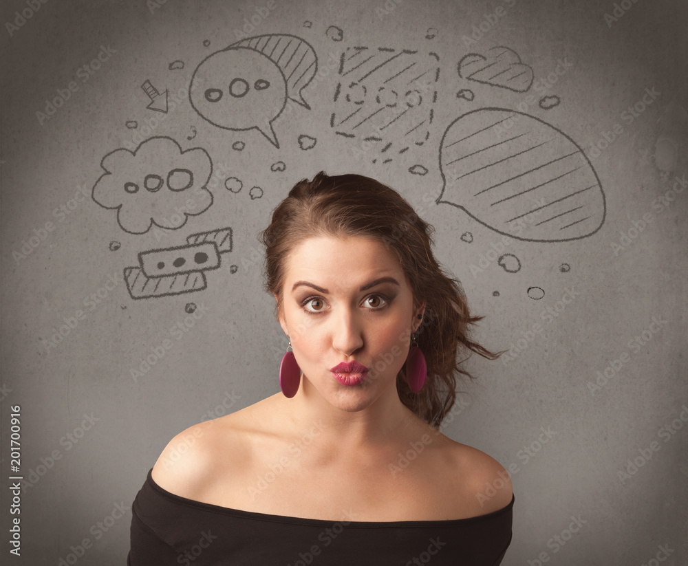 A cute female student making funny expressions with thoughts in her head illustrated by drawn chat bubbles on the urban wall background concept. A cute female student making funny expressions with thoughts in her head illustrated by drawn chat bubbles on the urban wall background concept.