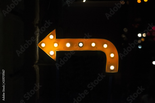 Orange arrow with light bulbs.