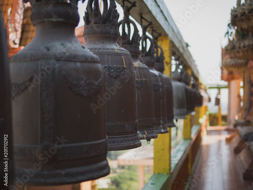 Buddhist bells in a temple, selective focus. ringing Buddhist bells is like say a prayer for good luck. Wat Tham Suea or Tham Suea temple, Kanchanaburi, Thailand.