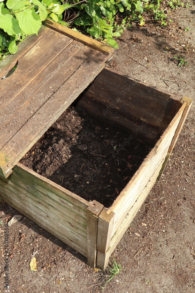 Ready made compost pile in open bin wood crate Ready made compost pile in open bin wood crate