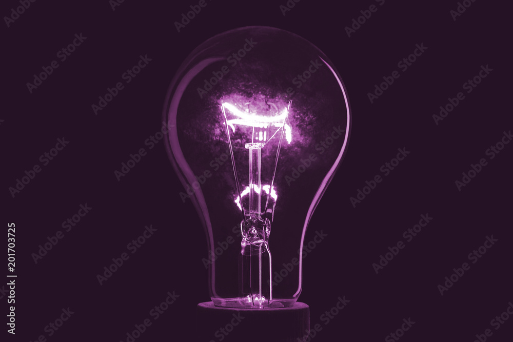 Abstract light bulb on the black background. Lamp light in the dark. Electric bulb. Glowing light in the dark. Abstract light bulb on the black background. Lamp light in the dark. Electric bulb. Glowing light in the dark.