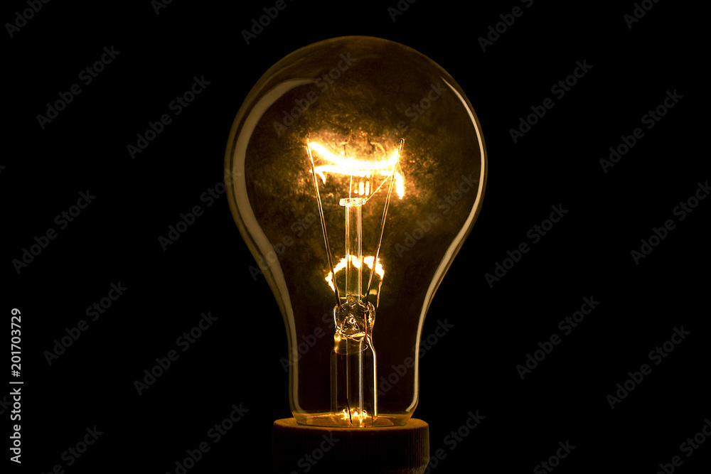 Abstract light bulb on the black background. Lamp light in the dark. Electric bulb. Glowing light in the dark. Abstract light bulb on the black background. Lamp light in the dark. Electric bulb. Glowing light in the dark.