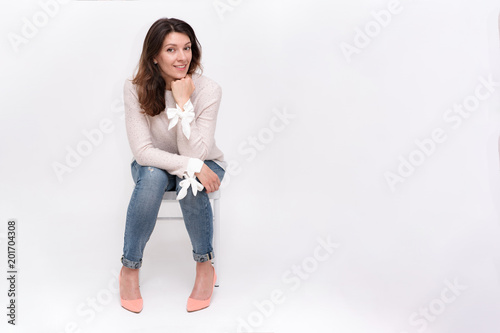 girl sitting on a chair on a white background in different poses