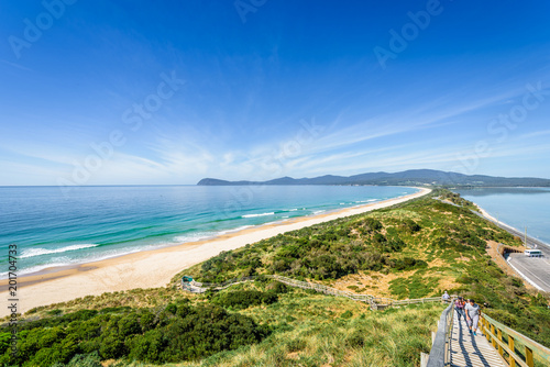 Fototapeta Naklejka Na Ścianę i Meble -  Amazing wooden view point over small green island sandy beach shore with turquoise blue water of southern ocean on a warm sunny blue sky day, The Neck, Bruny Island, Tasmania, Australia - 11-18-2017
