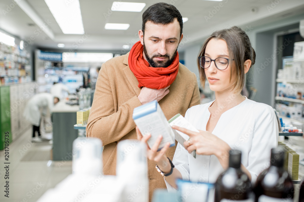 Pharmacist with client in the pharmacy store Pharmacist with client in the pharmacy store