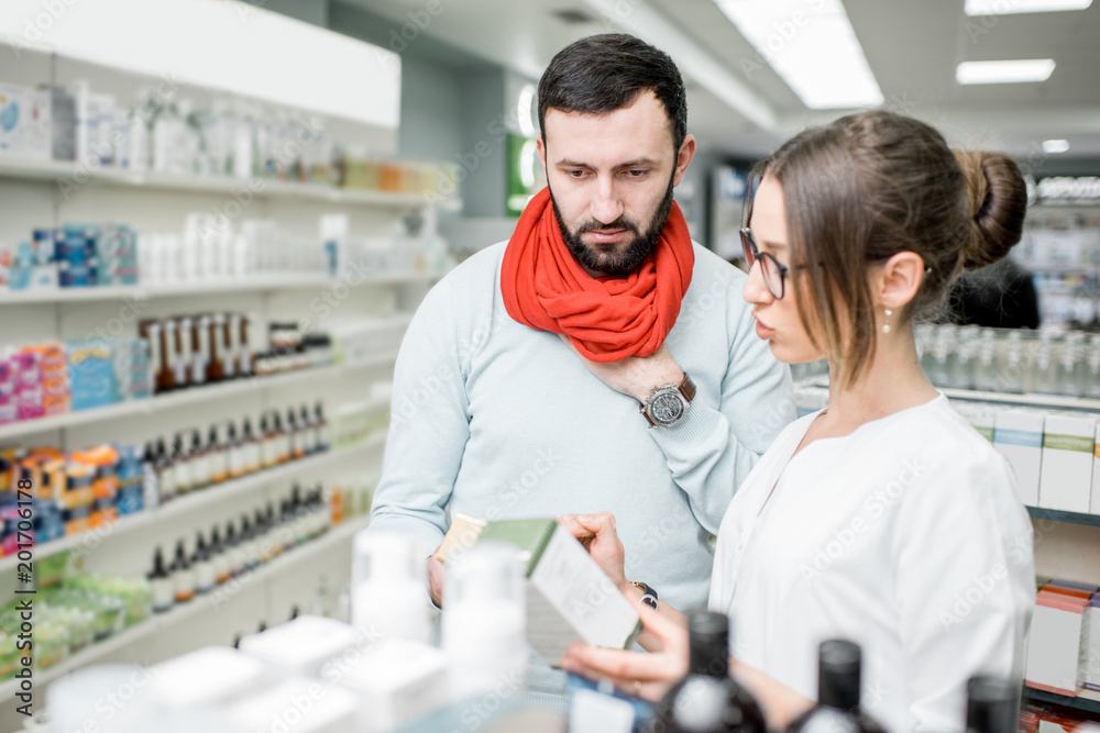 Pharmacist with client in the pharmacy store