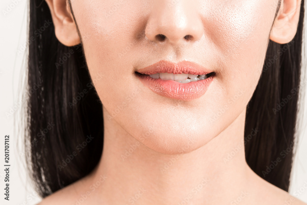 Close-up of female lips mouth biting lip isolated on white background