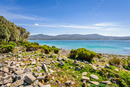 Amazing view to great paradise island sandy beach with turquoise blue water and green shore jungle forest on warm sunny clear sky relaxing day, Fluted Cape Track Bay, Bruny Island, Tasmania, Australia photo
