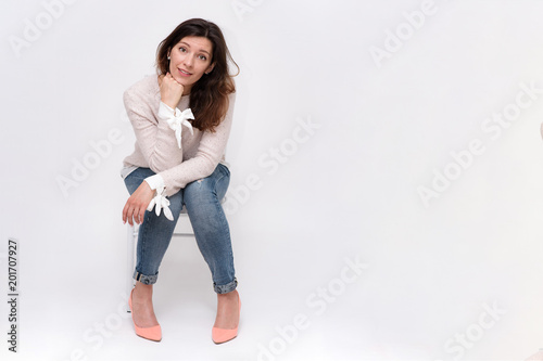 girl sitting on a chair on a white background in different poses