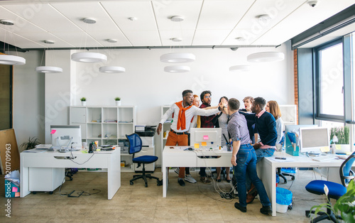 фотографія young active office workers are holding palms together to show their social cohesion