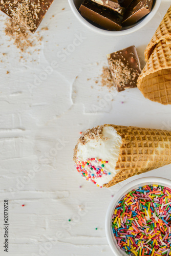 Ice-Cream Plombir In A Waffle Cup With A Topping Of Fresh Blueberries And Syrup, Grated Chocolate, Sprinkles, Overhead View.