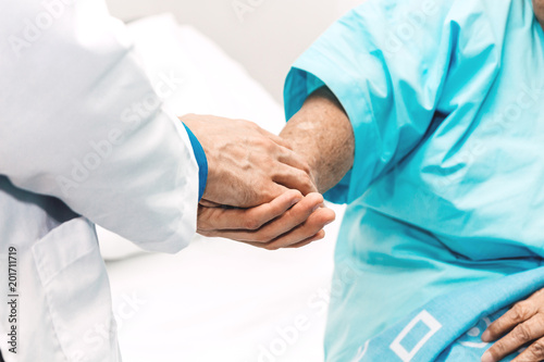 Doctor holding elderly person patient hand with care and consulting in hospital.healthcare and medicine