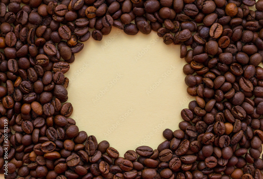 Roasted coffee beans with circle copy space in the middle. Aroma drink concept. Breakfast background. Coffee closeup with copy space. Cappuccino and espresso concept. Roasted coffee beans with circle copy space in the middle. Aroma drink concept. Breakfast background. Coffee closeup with copy space. Cappuccino and espresso concept.