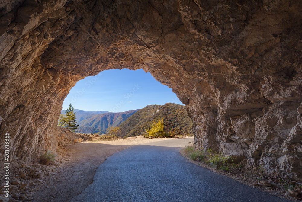 Driving through old rocky tunnel in remote part of Montenegro