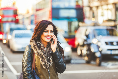 Indian woman talking on the phone in London