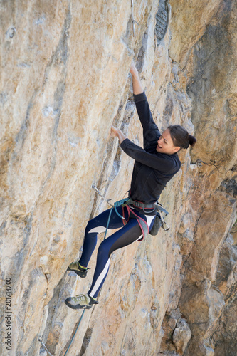 Woman climbs an overhang rock with a rope, lead © Александра Голубцова