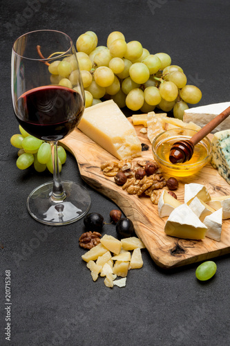 various types of cheese - brie, camembert, roquefort and cheddar and wine
