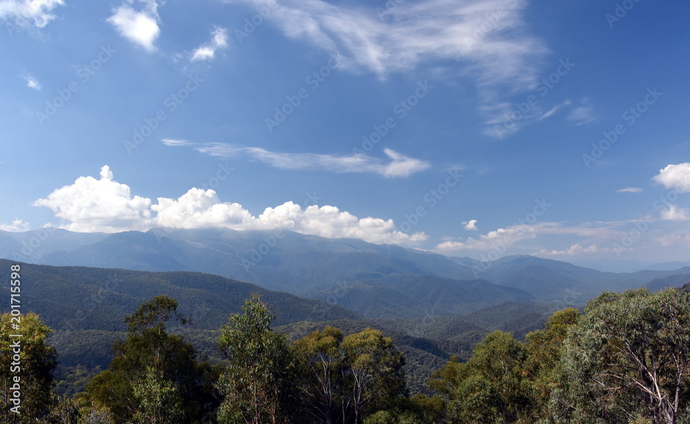 Fototapeta premium Broad panorama of the countryside in New South Wales with mountains. View from Snowy Surge Tower on Kosciusko Rd near Jindabyne, NSW, Australia.