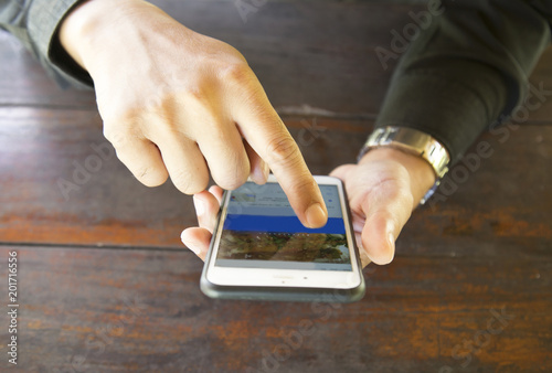 One man uses a mobile for business.