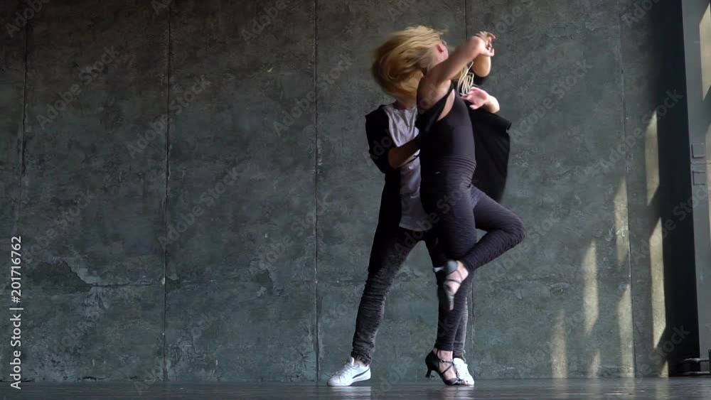 Beautiful couple of professional artists dancing passionate dance. slow-motion. Young couple dancing zouk dance Beautiful couple of professional artists dancing passionate dance. slow-motion. Young couple dancing zouk dance