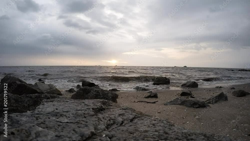 Timelapse of beautiful sunset at beach under cloudy weather and rainy day. Selective focus and crop fragment. Timelapse of beautiful sunset at beach under cloudy weather and rainy day. Selective focus and crop fragment.