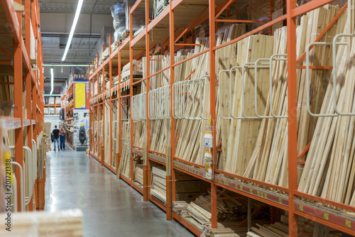 interior of hardware retailer with aisles, shelves, racks of building material insulation floor to ceiling.