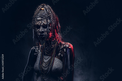 Close-up portrait of a witch from the indigenous African tribe, wearing traditional costume. Make-up concept.