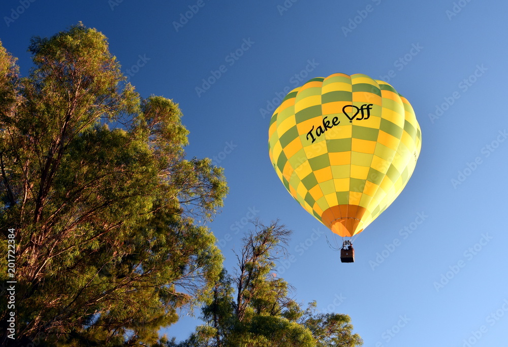 Fototapeta premium Canberra, Australia - March 10, 2018. Yellow Hot air balloon with 