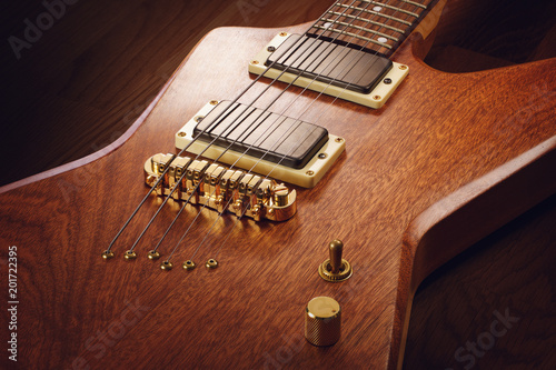 Close up on the body of electric guitar with natural finish, dark wooden background photo