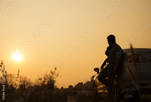 one man and the car with a trip before sunset.