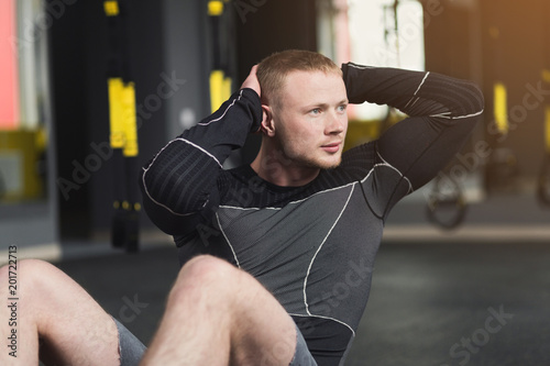 Young man fitness workout, sit-up crunches for abs photo