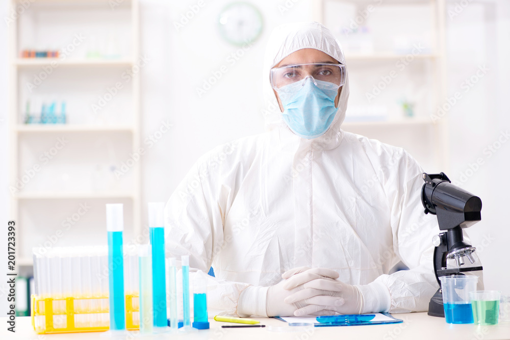 Young chemist student working in lab on chemicals Young chemist student working in lab on chemicals