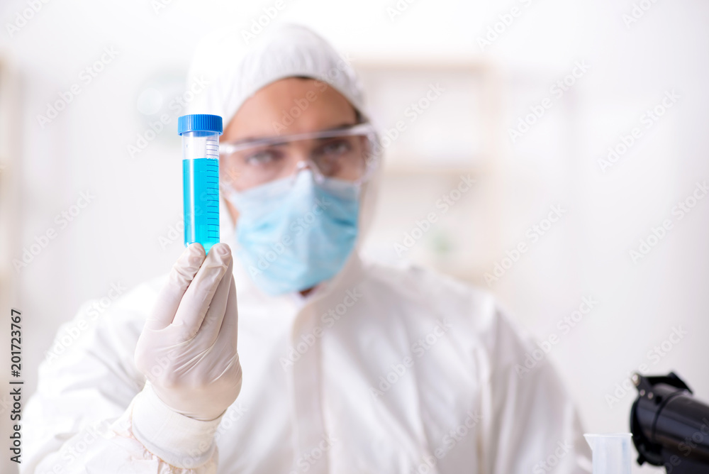 Young chemist student working in lab on chemicals Young chemist student working in lab on chemicals