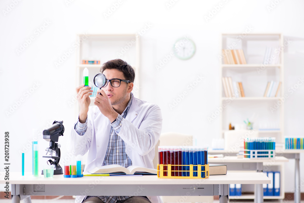 Chemistry student doing chemical experiments at classroom activi Chemistry student doing chemical experiments at classroom activi